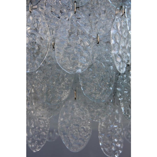 This Murano Glass pendant light from Vistosi is made with hammered glass. Up to 250V (Europe/UK Standard).The wiring of...