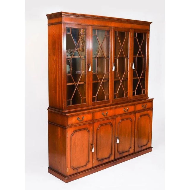 A delightful Vintage petite flame mahogany Georgian Revival library bookcase, dating from the mid-20th Century. The top...