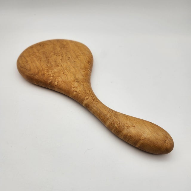 Hand-carved maple hand mirror with sculpted ergonomic handle and inset beveled glass