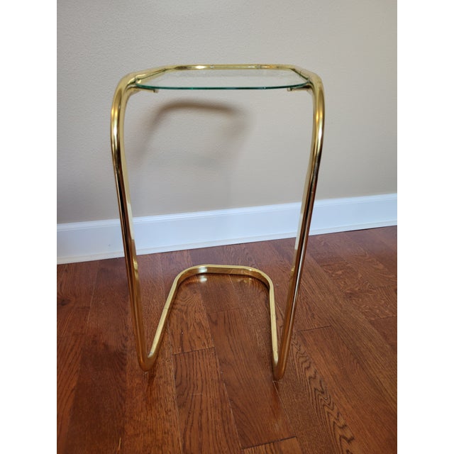 These classy little tables can be hard to find. This brass and glass cantilever side table is perfect in small spots. A...