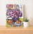 The radiance of flowers, pattern and color unite in this engaging contemporary 14" x 11" still life oil painting. This...