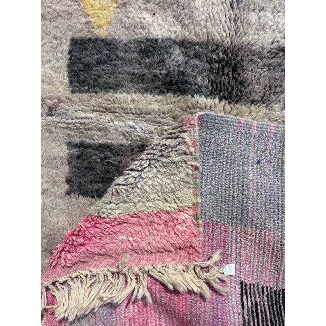 Handwoven in Morocco from natural wool, this contemporary Boujad rug features a striking abstract composition combining...
