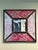 This striking 23" x 23" vintage Peruvian reverse painted glass mirror features a vibrant, hand-painted floral and foliate...