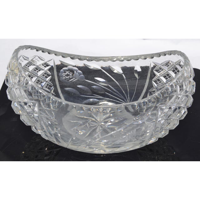 Charming boat-shaped cut glass bowl with intricate diamond and floral patterns, featuring a scalloped edge and a deep,...