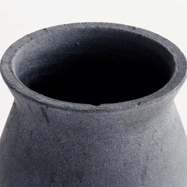 This roughhewn terracotta vase really brings the drama. The handrubbed finish and intentionally rough surface add a touch...