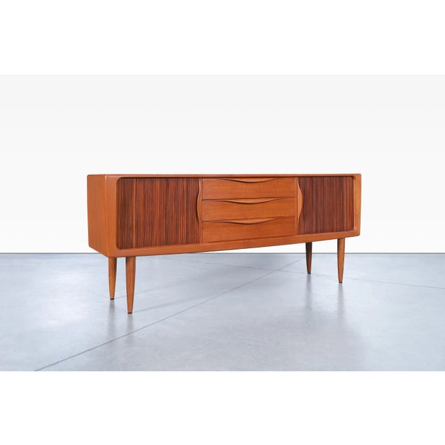 Beautiful Danish modern teak tambour door credenza designed in Denmark, circa 1960s. This piece features a well-crafted...