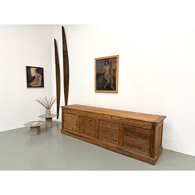 A truly impressive piece of craftsmanship. This very large shop counter, dating from the 1920s, is made of solid pine and...