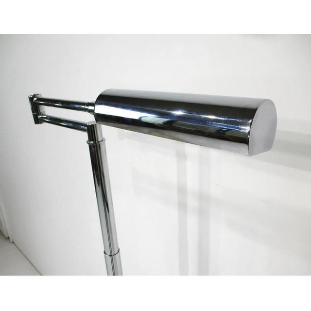 Mid-century modern chrome swing-arm floor lamp, designed in the style of Koch & Lowy, features a distinctive rectilinear...