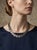 This articulated metal collar necklace is a striking statement piece that beautifully balances structured geometry with...