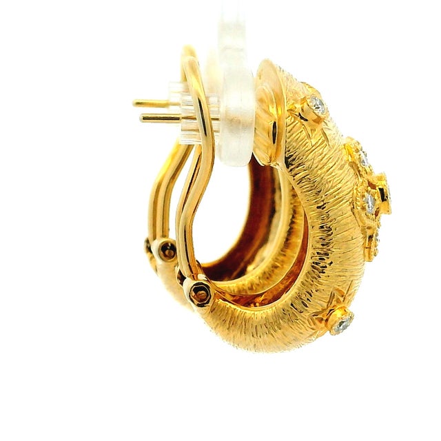 Elegant vintage earrings crafted in solid 14 karat yellow gold, featuring approximately 1.00 carat total weight of round...