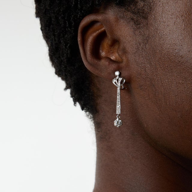 A graceful expression of Mid Century elegance, these vintage drop earrings showcase twenty round brilliant and single cut...