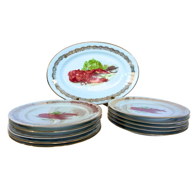 A captivating 1930s French Limoges porcelain set featuring a bold and elegant lobster motif, perfect for seafood lovers...