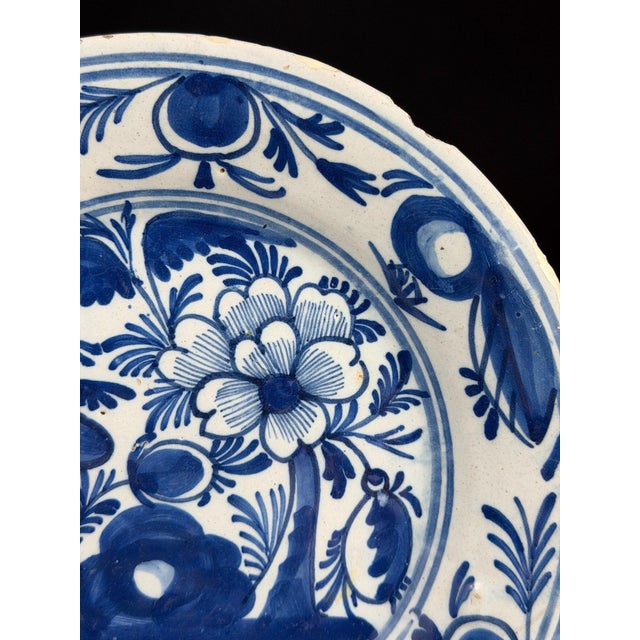 This attractive Dutch Delft faience plate is decorated in a rich cobalt blue palette against a creamy tin-glazed ground,...