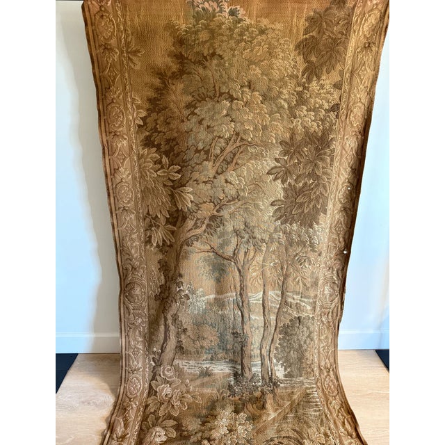 An exquisite and rare 19th century French Aubusson tapestry. This handwoven piece features a lush landscape and warm...