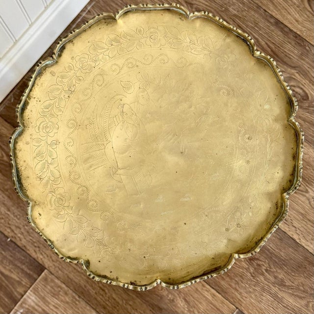 A distinctive vintage Chinese occasional table featuring two removable brass trays resting on a slender dark wood frame....