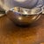 Beautiful, pristine example of the iconic Nambé #527 Tri-Corner 9-inch bowl. Designed by legendary mid-century modernist...