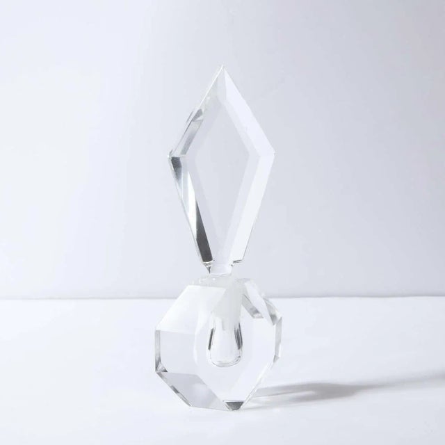 This stunning 1940s Hollywood Regency perfume bottle was realized in the United States, circa 1945. It features hexagonal...