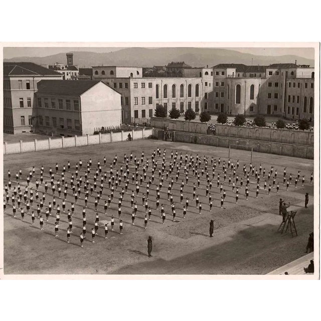 Boys in lines of practice is an original black and white photograph realized by an Anonymous photographer in the 1930s....