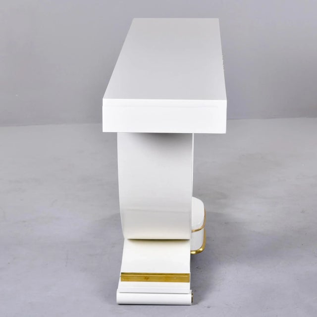 Found in France, this console has a curved support and stepped platform base. New, professionally applied white finish...
