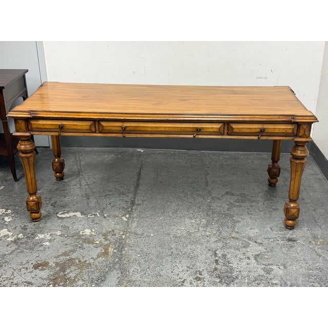 Design Plus Gallery presents a Bespoke Library Desk. This traditional library desk has a honey-brown wood tone, a...