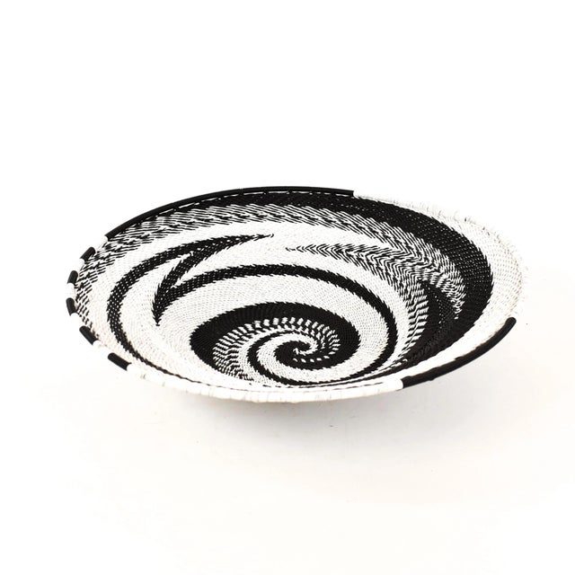 Zulu Telephone Wire Baskets from South Africa epitomize the fusion of traditional craftsmanship and contemporary...