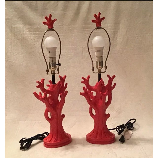 These are beautiful coral orange in color, cast resin pair of table lamps with original matching finials. Shaped to...