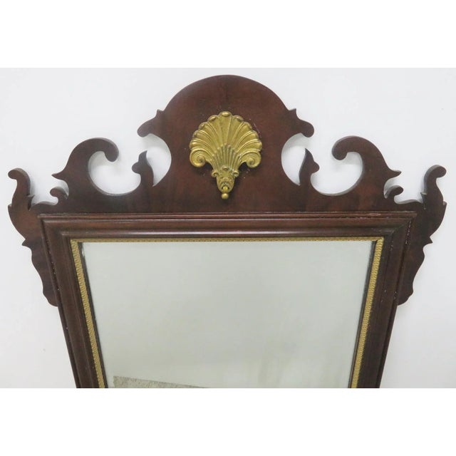 Mahogany Chippendale style mirror made by Council furniture , carved gold gilt shell on top, beveled mirror