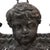 This antique hanging planter, crafted from wrought iron, dates to approximately 1920. The piece features a central figural...