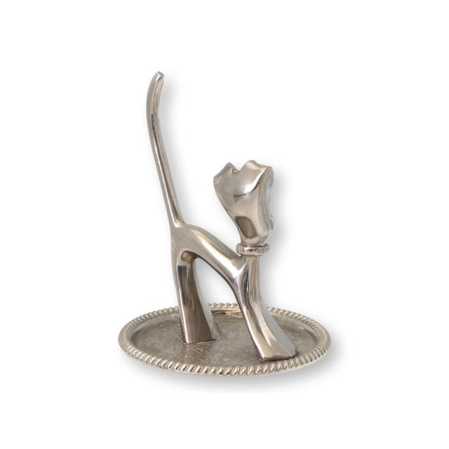 Mid 20th century Art Deco style dog ring holder with expressive stylized form. Cast in silver metal and mounted on an oval...