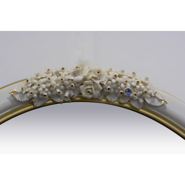This elegant Italian wall mirror by Giulio Tucci showcases the refined craftsmanship of authentic Capodimonte porcelain...