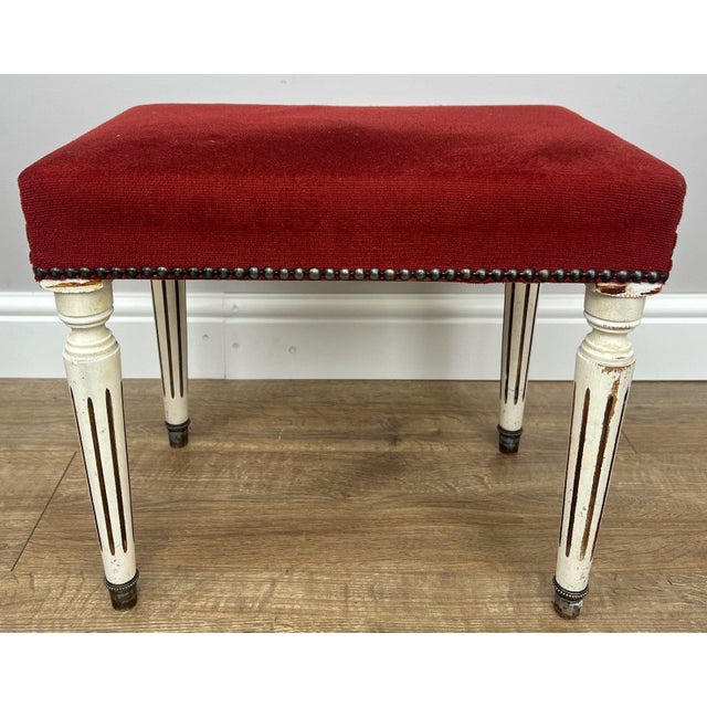 A charming Vintage French footstool , beautifully upholstered in a rich red fabric that brings warmth and character to any...