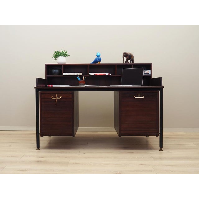 The desk was made in the 1970s, Danish production. The wooden structure was covered with oak veneer. The legs are made of...