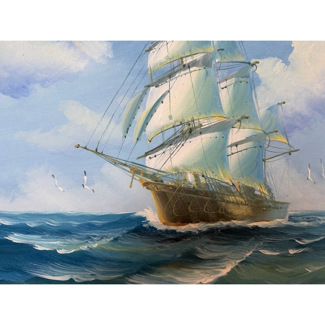 Oil on canvas maritime painting depicting a graceful sailing vessel cutting through rolling ocean waves beneath a luminous...