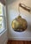 Large brass globe light by Morris & CO. Truly a work of art, the brass-finished pendant radiates a dramatic glow for a...