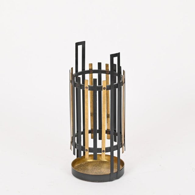 Wonderful and highly architectural Mid-Century umbrella stand crafted in a refined combination of black lacquered iron and...