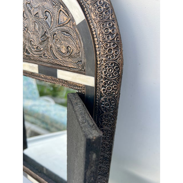 Vintage handmade Moroccan arch door mirror crafted from brass and featuring bone inlay details. The design is reminiscent...