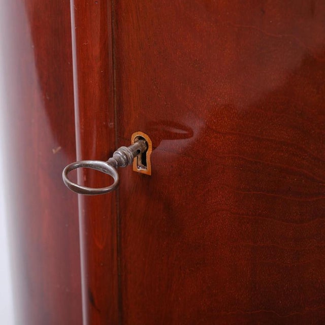 Small barrel cabinet / bar cabinet, Biedermeier style, Denmark, circa 1830, mahogany, oval shape, two full shelves and one...