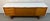 This vintage Mid-Century Modern sideboard was manufactured by Stonehill Furniture in England and features distinctive sled...
