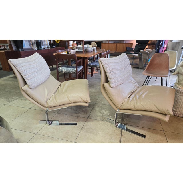 Very comfortable and elegant lounge chairs feature tan leather with a woven upholstered over hang cushion resting on...