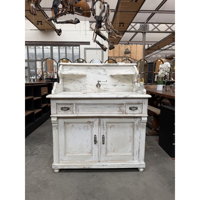 This antique marble and wood washstand has been fully restored. It features a complete mechanism that allows it to...