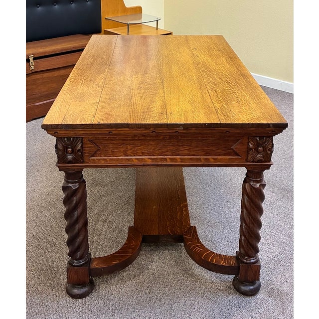 Handsome and Sturdy Oak Library Table with elaborate carving detail. Single drawer on either side of Table for storage. C....