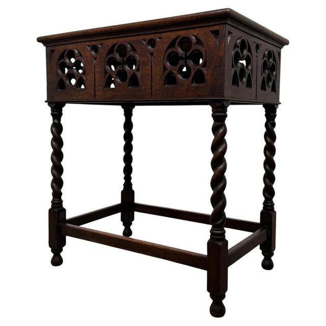 A handsome and highly decorative 20th-century Gothic style side table, beautifully crafted in oak and distinguished by its...