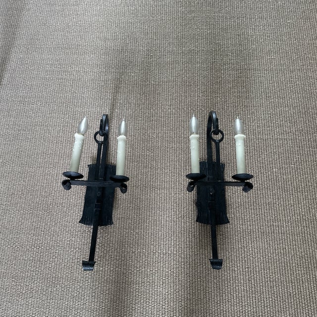 Solid double wrought iron metal candle sconces with carved etching and rolled metal details.