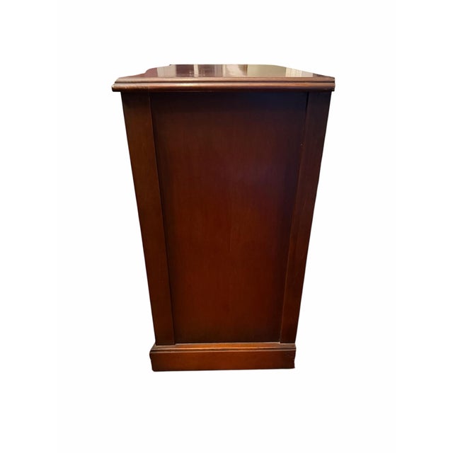 A circa 1940s Cordell mahogany bachelor’s chest featuring a graceful serpentine front, warm mahogany veneers, and classic...