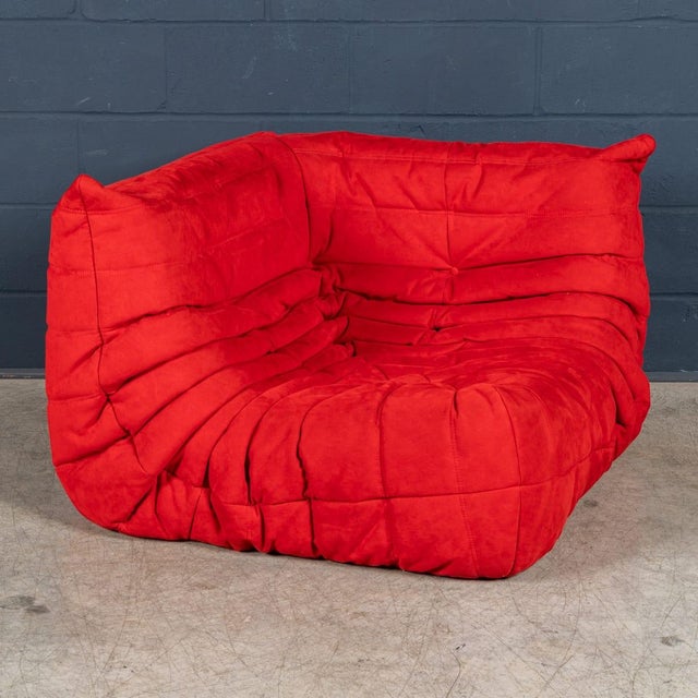 The iconic "Togo" sofa, originally designed by Michel Ducaroy for Ligne Roset in 1973, has become a mid-century design...