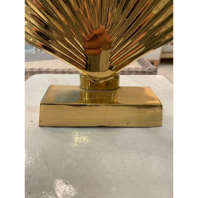 Add a touch of classic elegance to your home with this vintage polished brass shell door stopper. Featuring a beautifully...