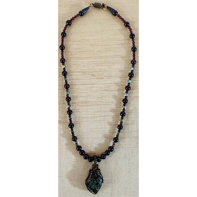 This stunning handmade vintage necklace features a large bloodstone wrapped in an antiqued copper pendant, complemented by...