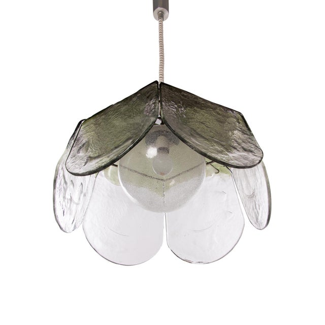 Elegant pendant light with large and heavy, clear and green murano glass petals on a metal frame and a big bubble glass...