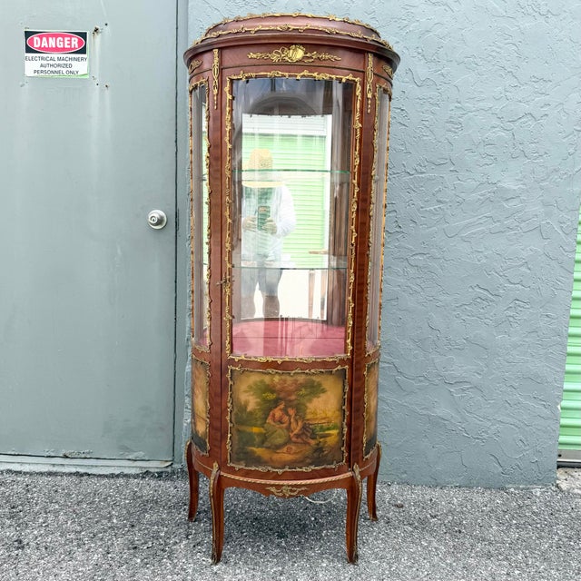 An elegant Antique French Louis XV-style display cabinet, crafted in Spain with a gracefully bowed serpentine silhouette...