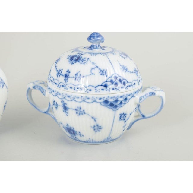 Royal copenhagen blue fluted half lace creamer and sugar bowl, late 20th century. Set consisting of a creamer and a sugar...